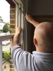 Man servicing window frames.