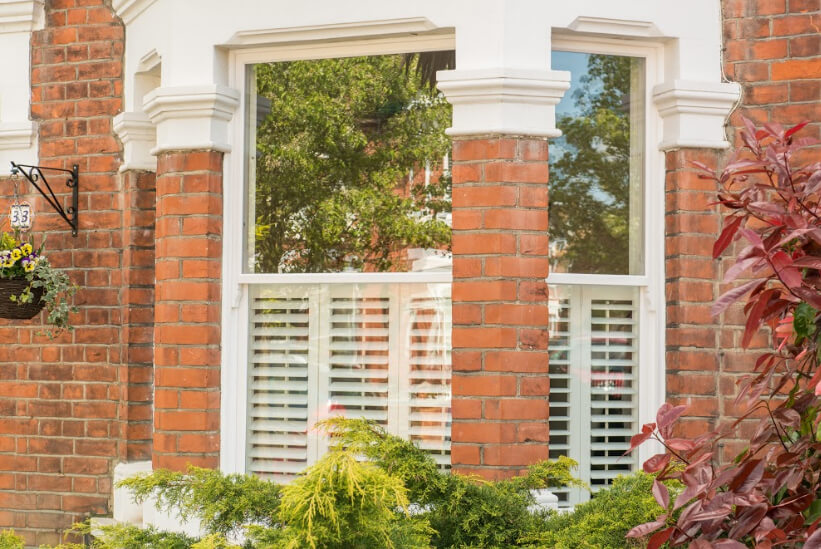 Outside shot of shutters on a red brick home